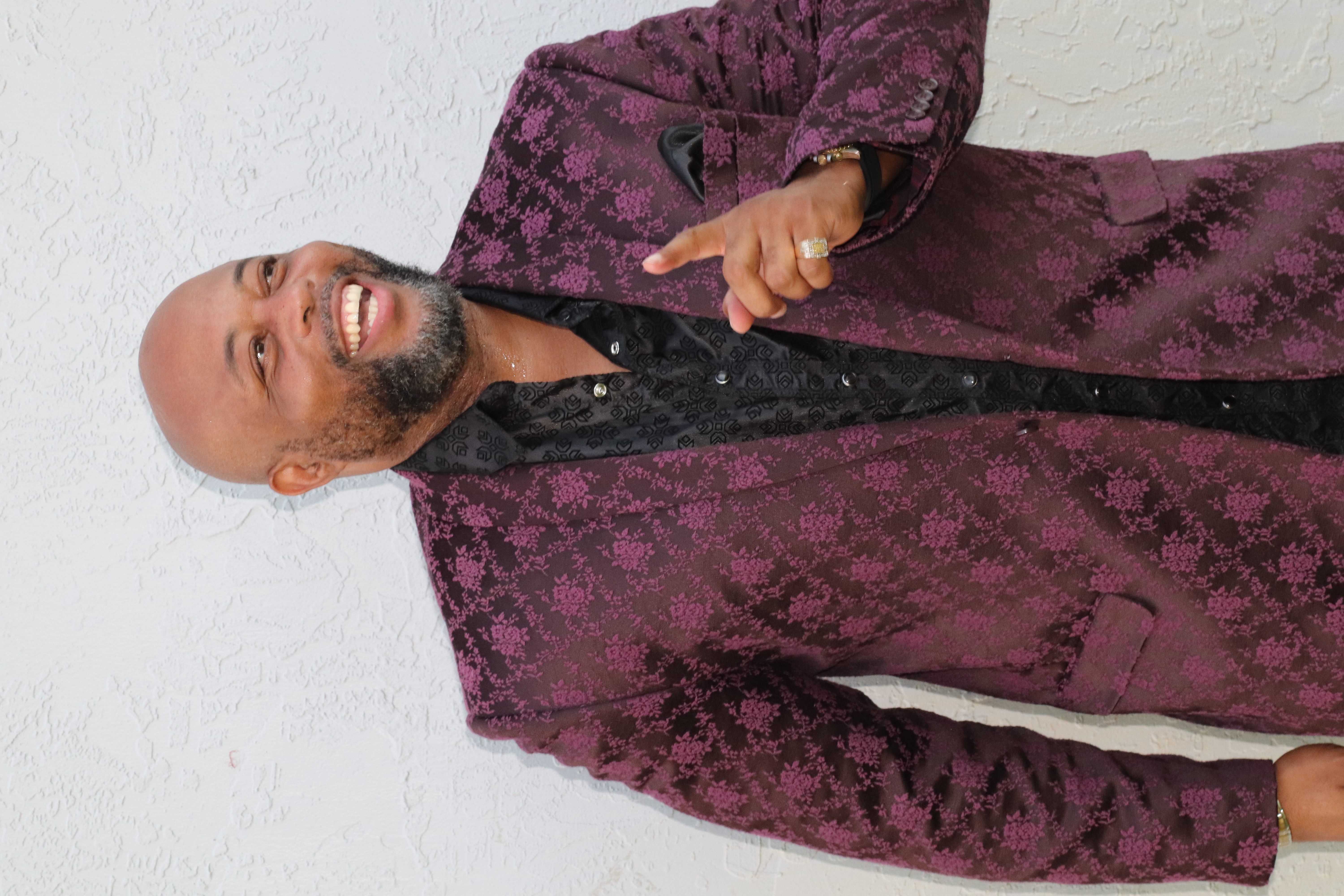 Gary Simmonds smiling in a patterned jacket